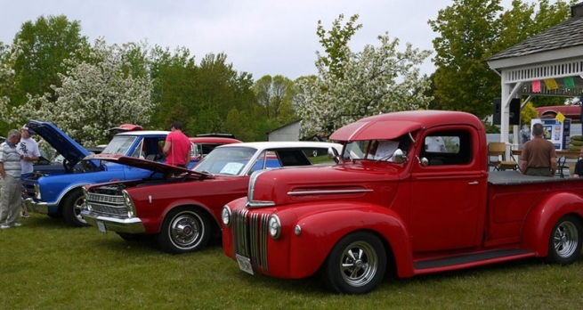 Photo of classic cars taking part in car show